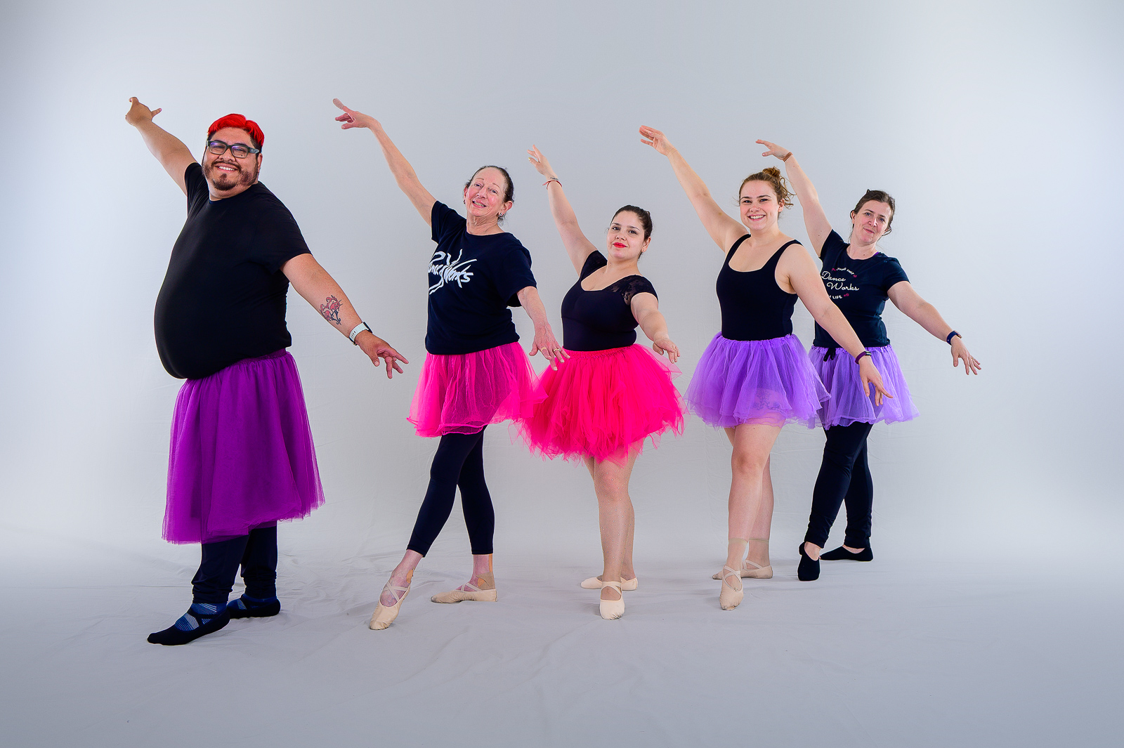 Adult ballet dancers posing in class